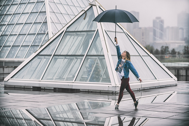 Girl dancing with an umbrella at Muttart Conservatory in Strathearn Edmonton